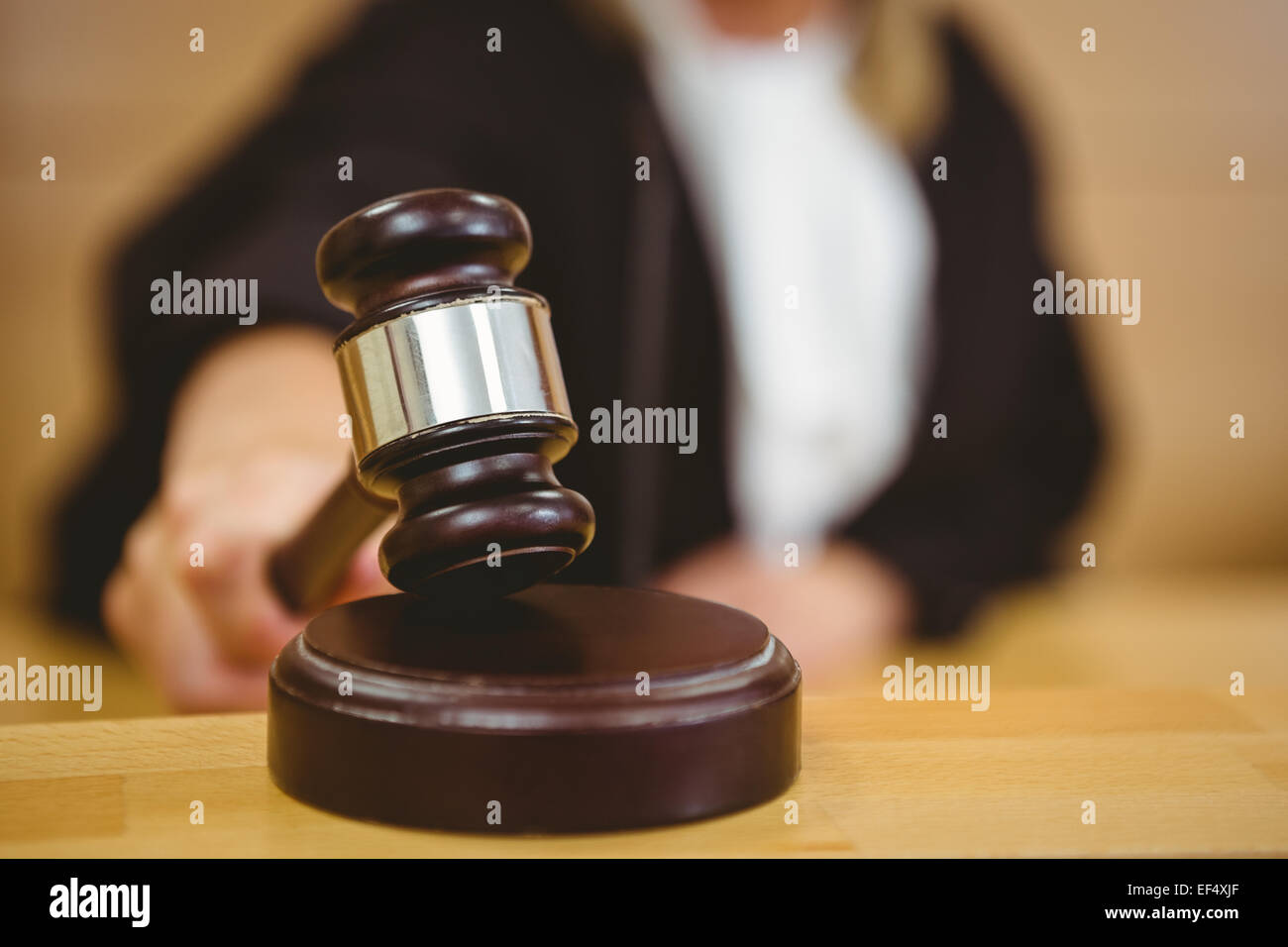 Hand about to bang gavel on sounding block Stock Photo Alamy