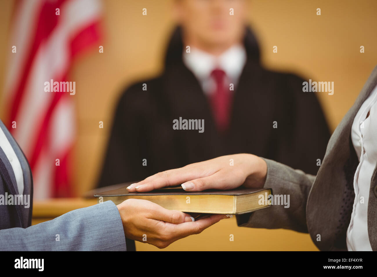 Witness swearing on the bible telling the truth Stock Photo
