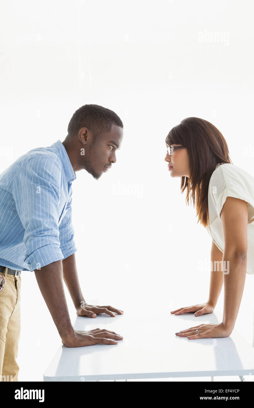 Business teamwork having a stand off at their desk Stock Photo