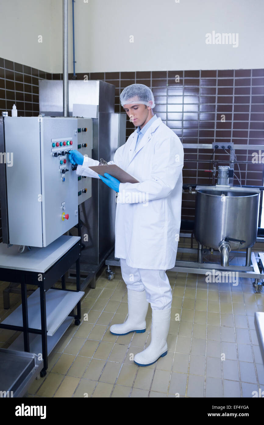 Focused biologist with safety gloves holding clipboard Stock Photo