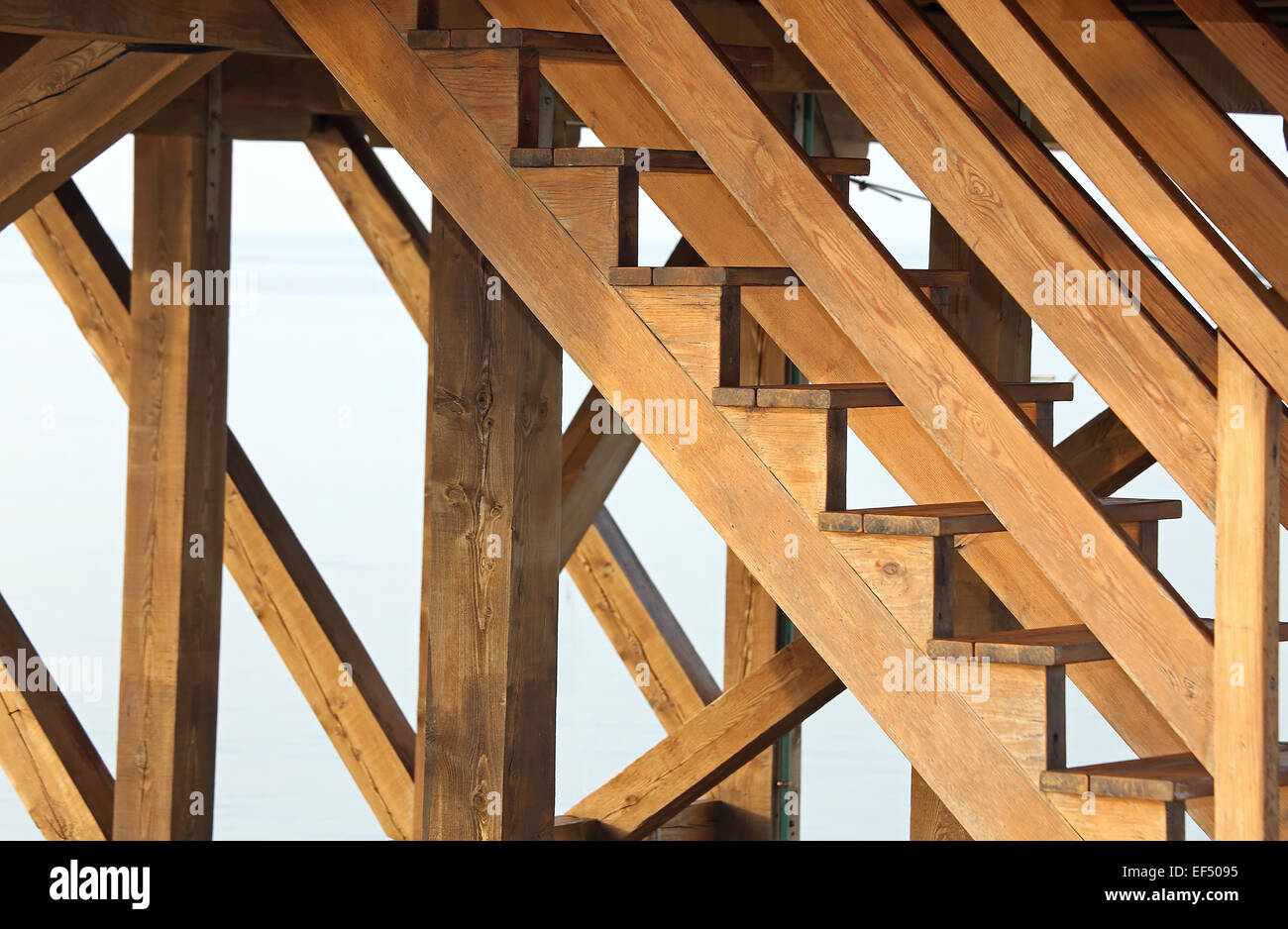 large complicated wooden staircase to climb above a wooden Stilt House overlooking the sea Stock Photo