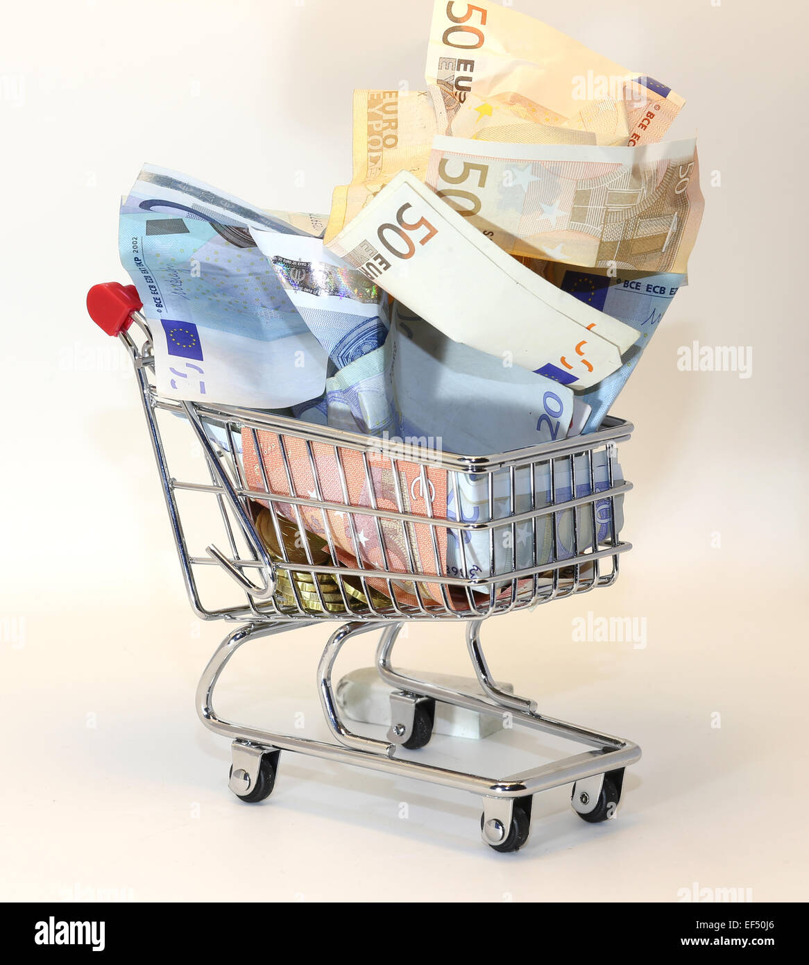 european shopping cart full of crumpled euro money Stock Photo