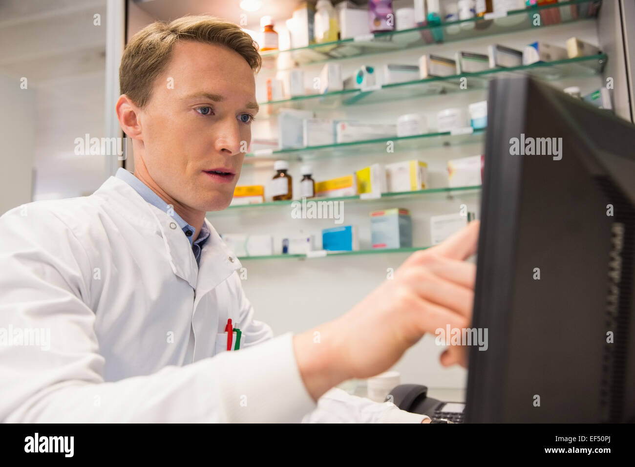 Pharmacist Using A Computer Focused pharmacist using the computer Stock Photo - Alamy