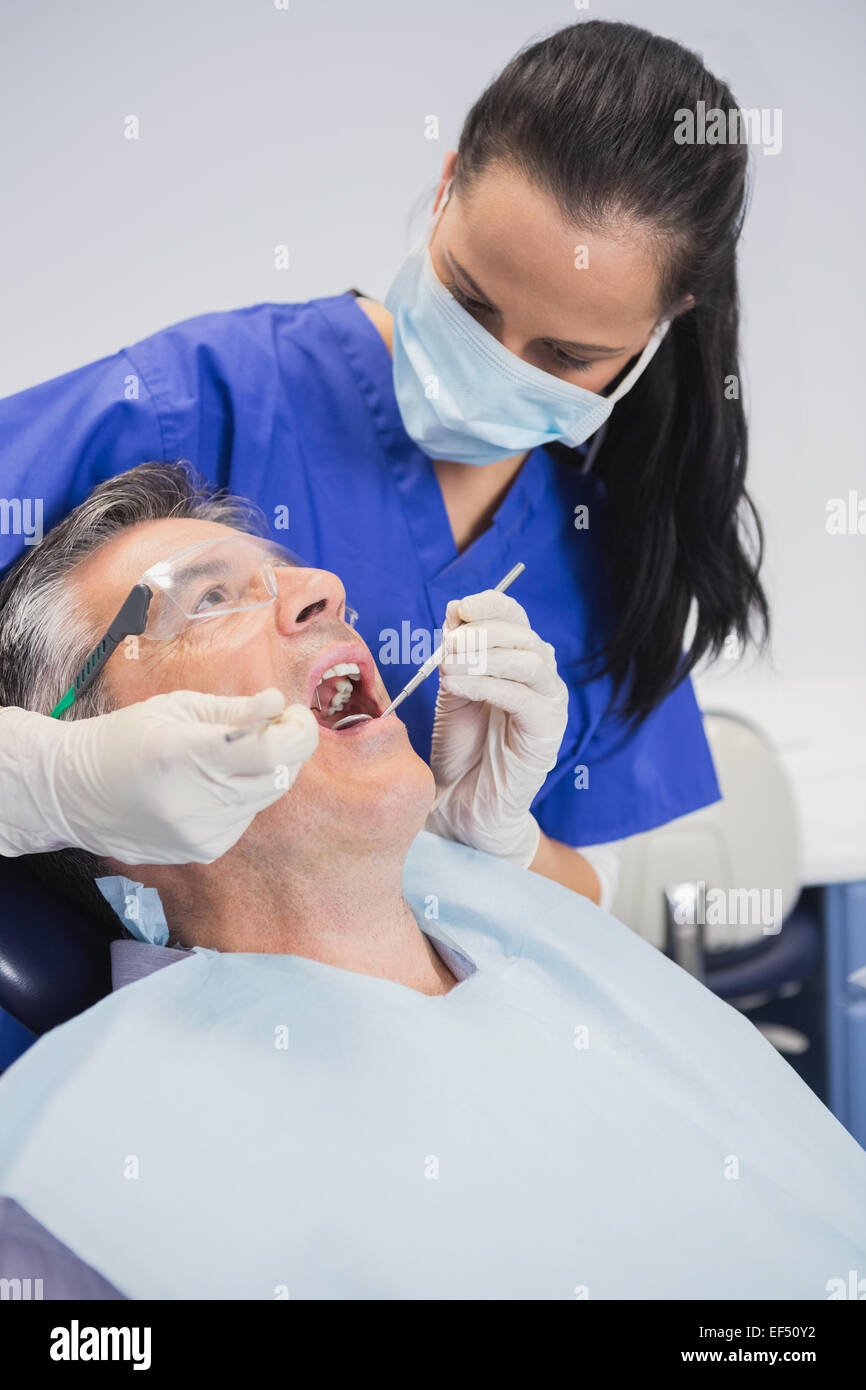 Dentist wearing surgical mask Stock Photo Alamy