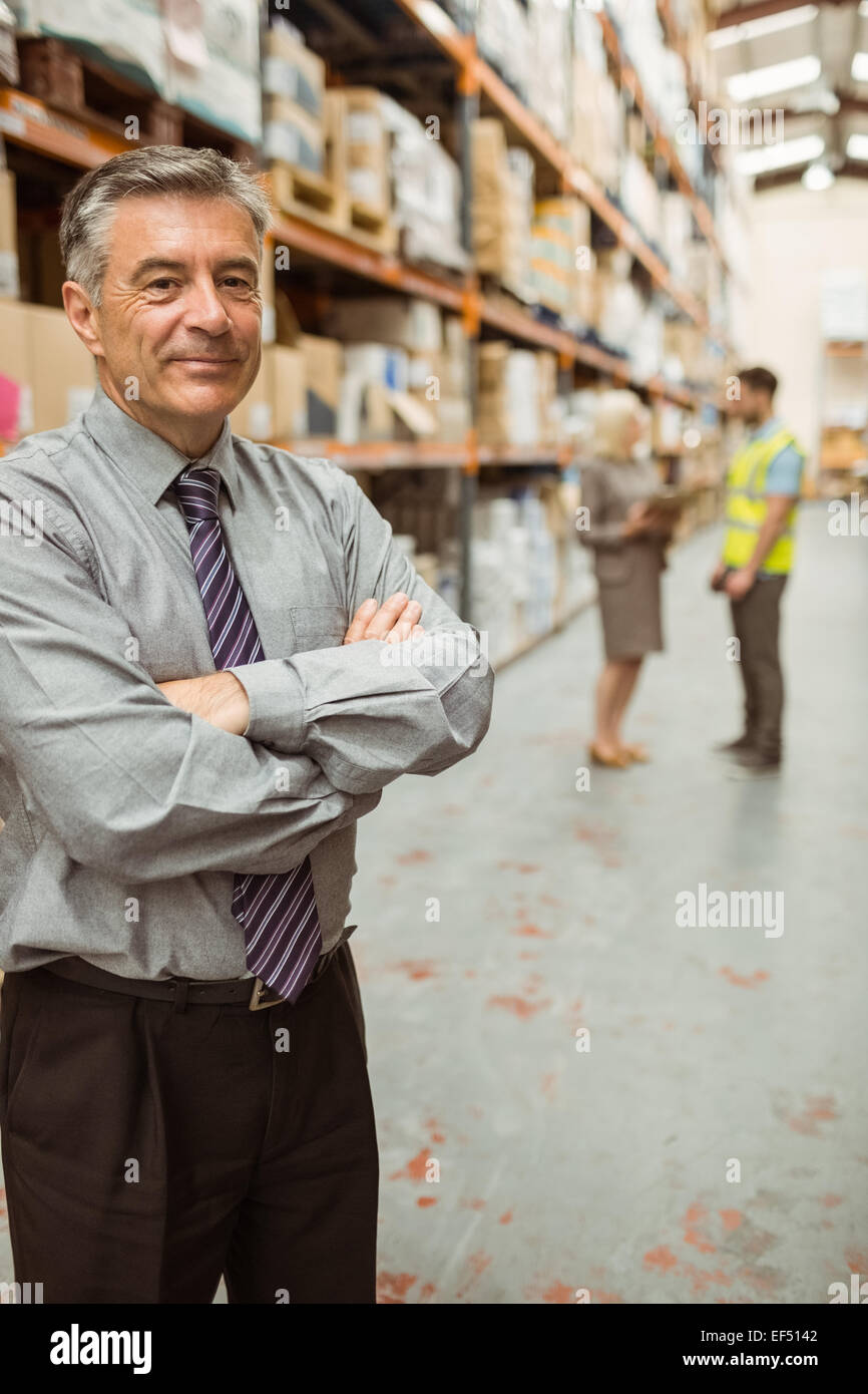 Smiling businessman with crossed arms Stock Photo - Alamy