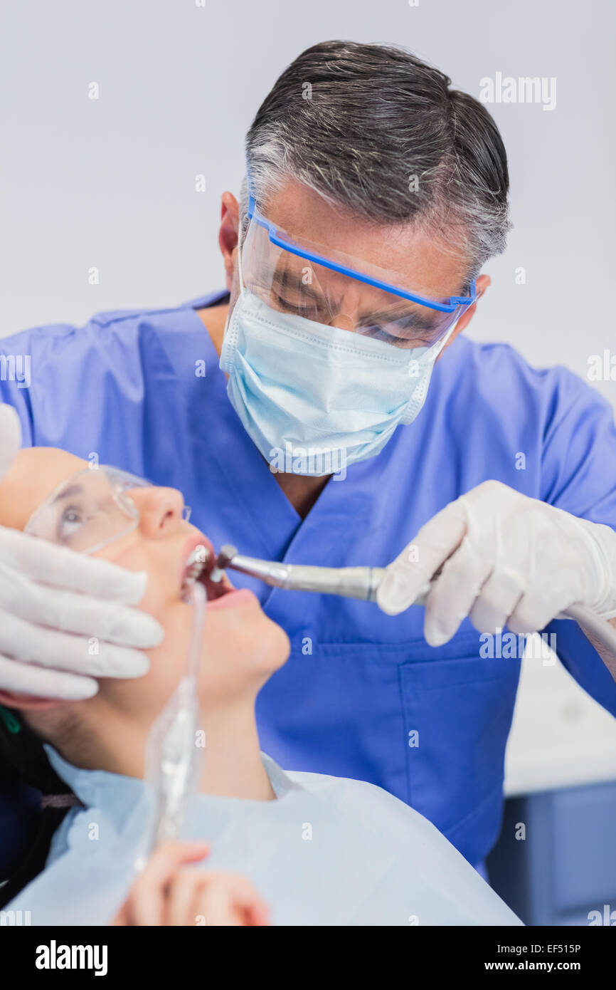 Dentist wearing surgical mask and safety glasses Stock Photo - Alamy