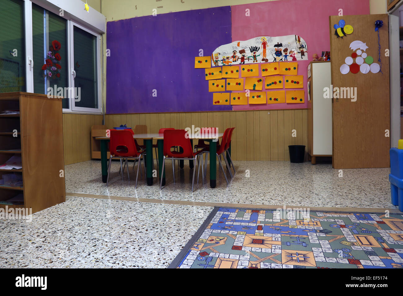 Preschool Classroom With Red Chairs And Table With Drawings Of