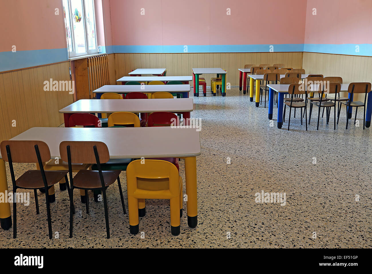 large refectory of kindergarten with small tables and chairs for children Stock Photo