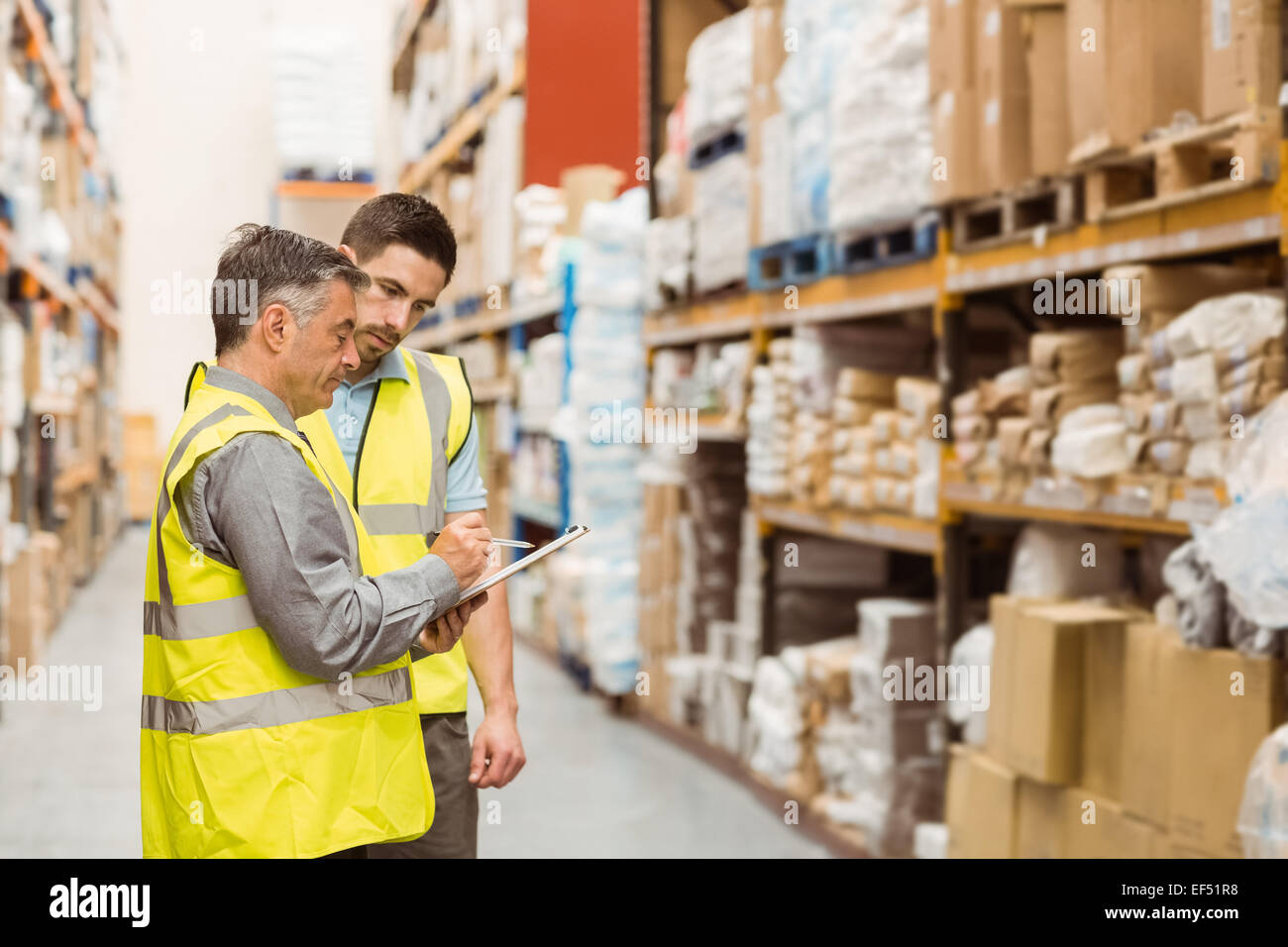 Warehouse workers talking together at work Stock Photo - Alamy