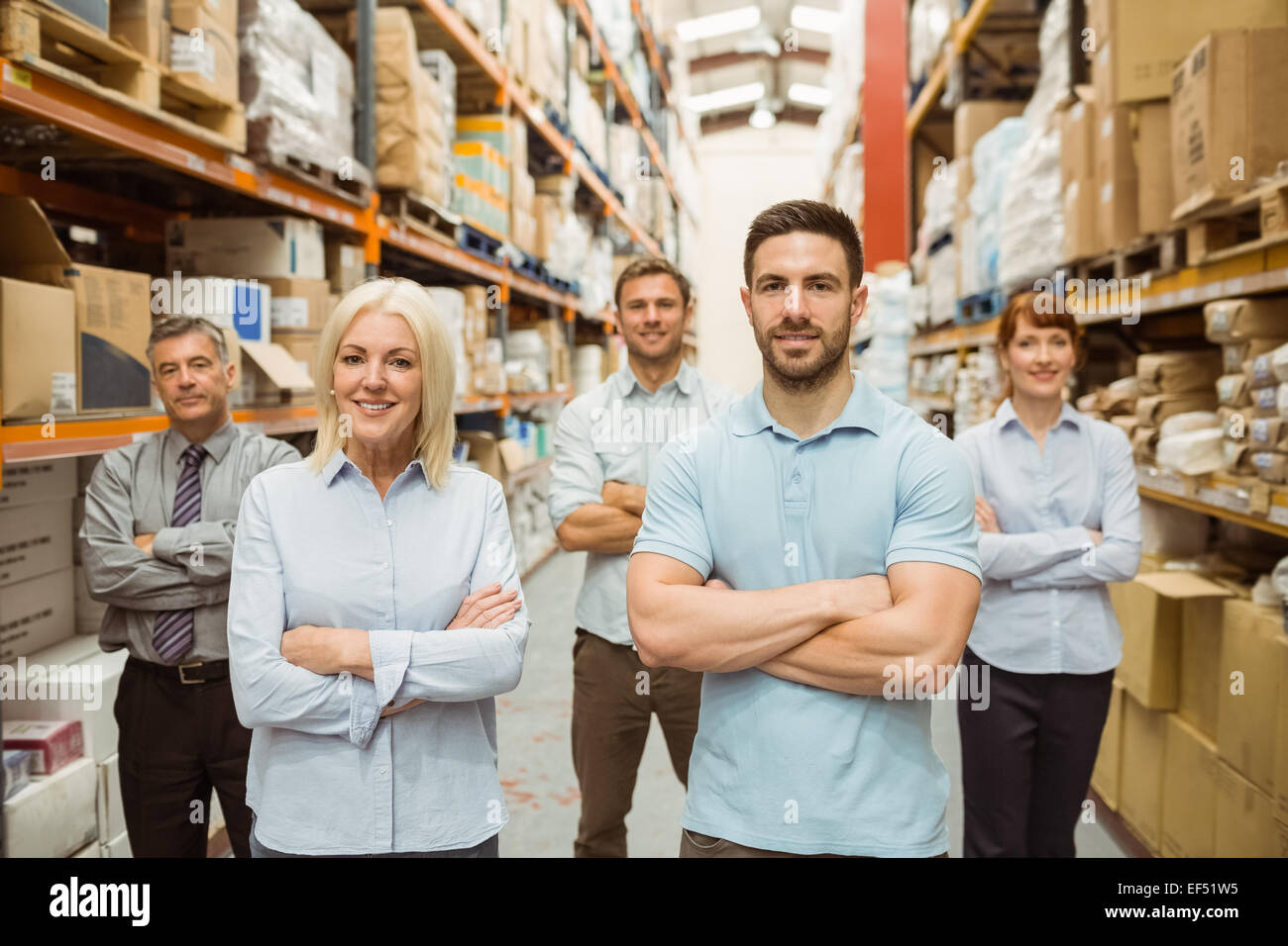 Smiling warehouse team with arms crossed Stock Photo - Alamy