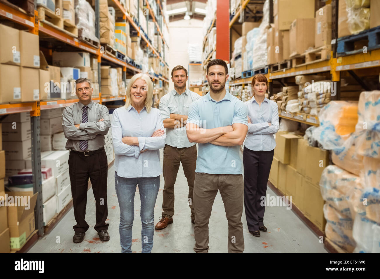 Smiling warehouse team with arms crossed Stock Photo - Alamy