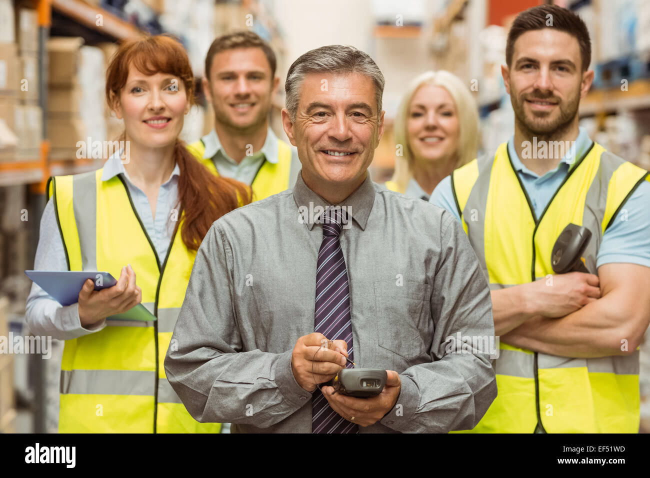 Smiling warehouse team with arms crossed Stock Photo - Alamy