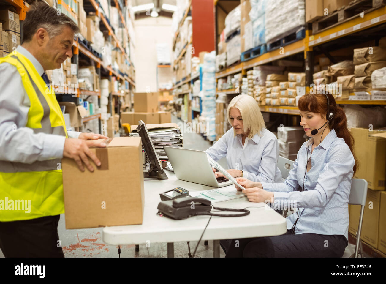 Warehouse team working together on shipment Stock Photo - Alamy