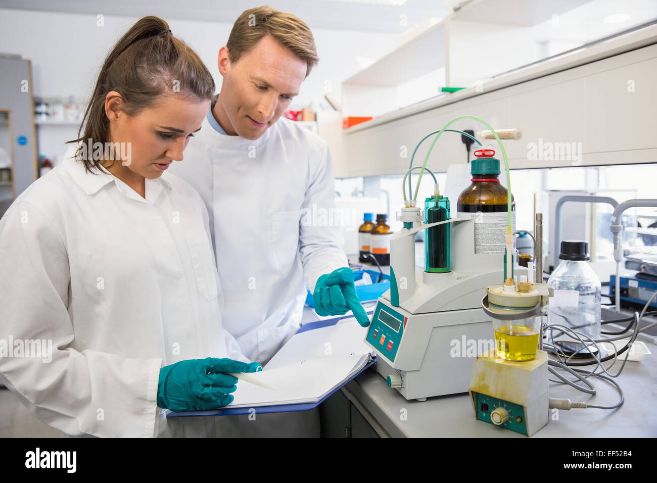 Young scientists conducting an experiment together Stock Photo - Alamy