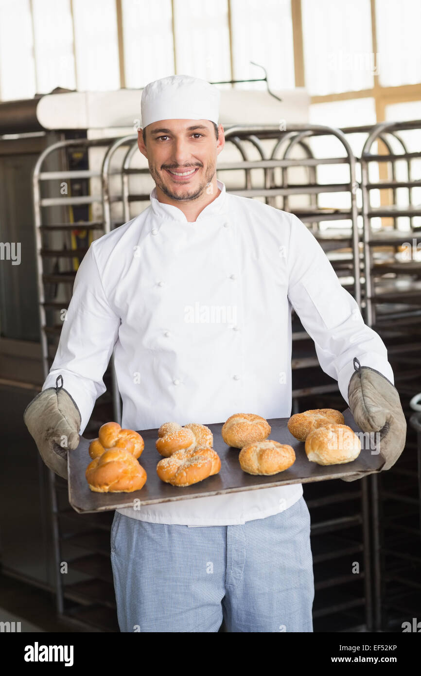 Baker showing tray of rolls Stock Photo - Alamy