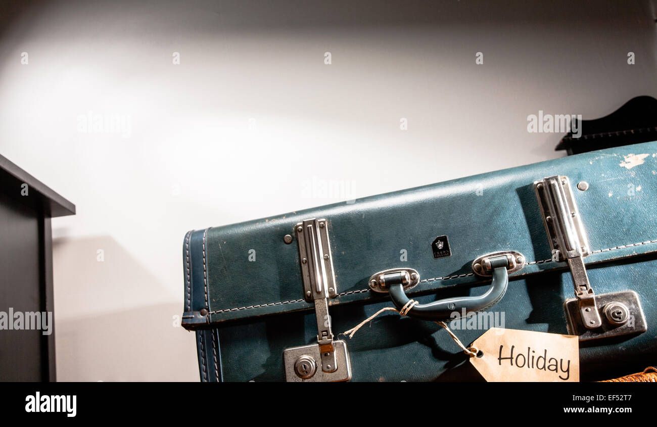 Vintage suitcase with Holiday luggage tag. Stock Photo