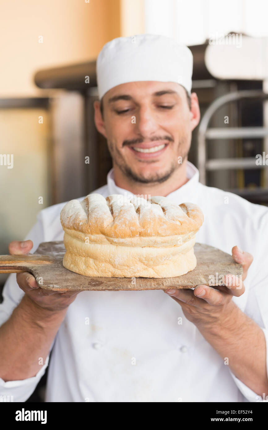 Baker showing freshly baked loaf Stock Photo Alamy