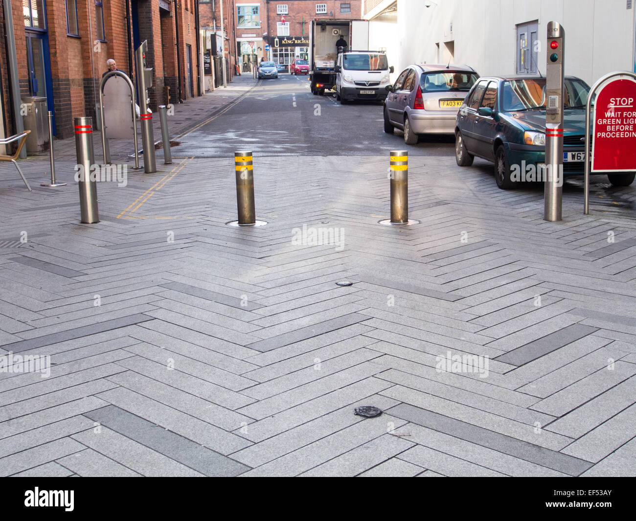 Automatic street security bollards of polished steel with traffic