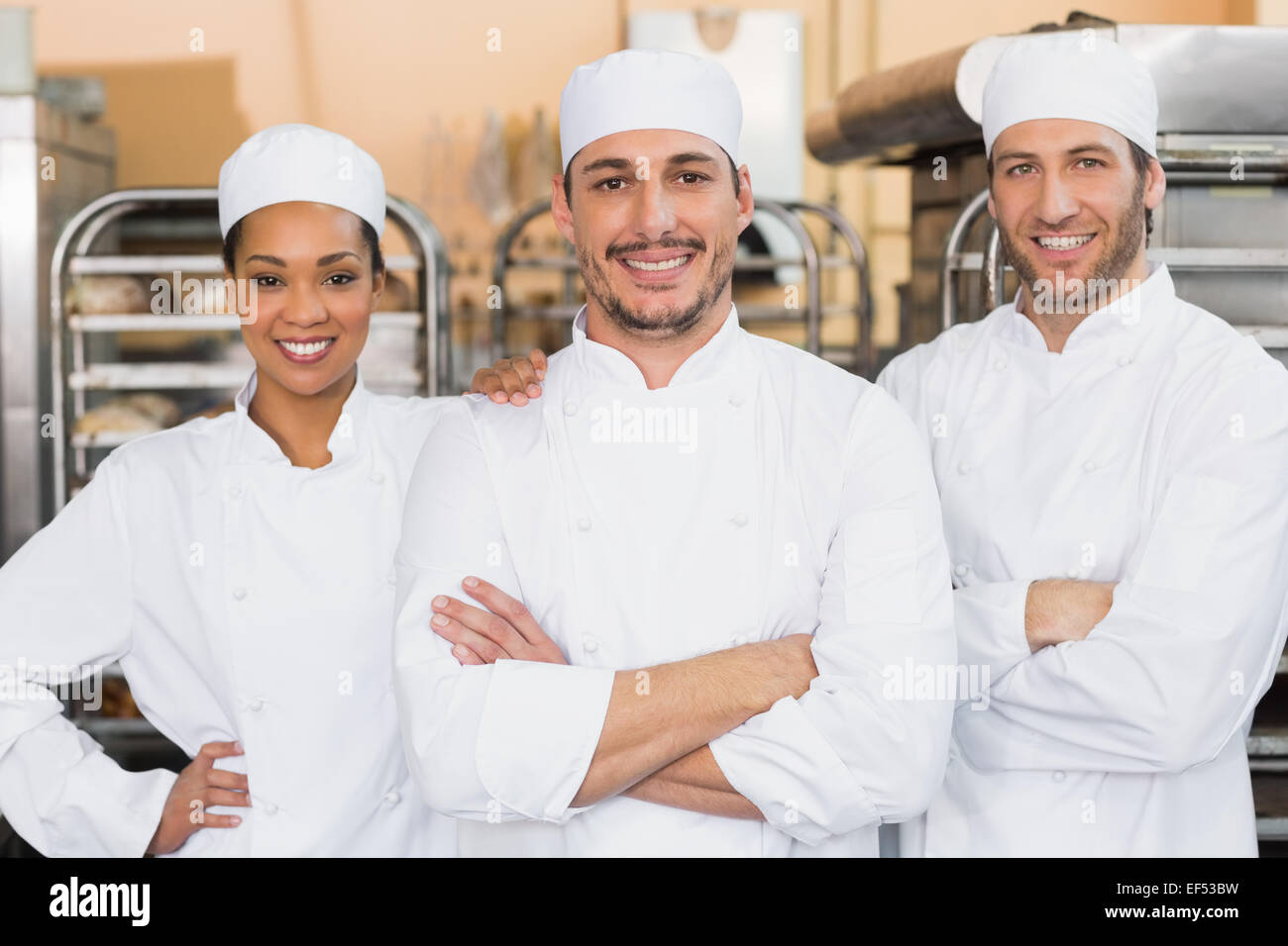 Team of bakers smiling at camera Stock Photo