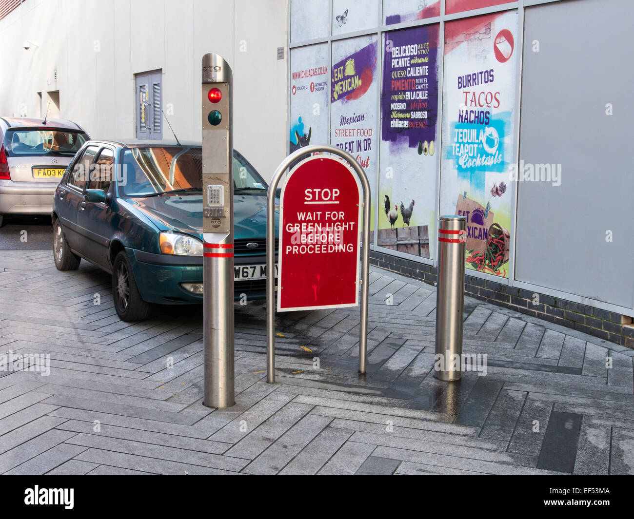 Automatic street security bollards of polished steel with traffic