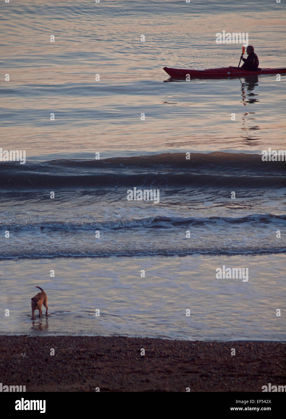 A canoeist glides across a calm sea at Brighton Stock Photo