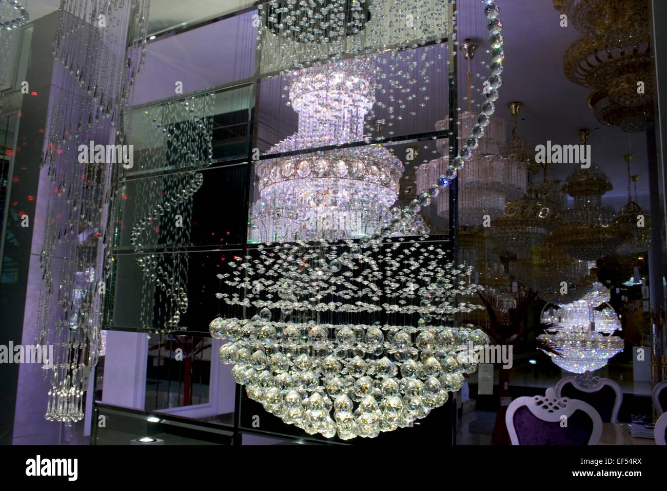 A chandelier is seen on display through a glass window at a light store in Phnom Penh, Cambodia. Stock Photo