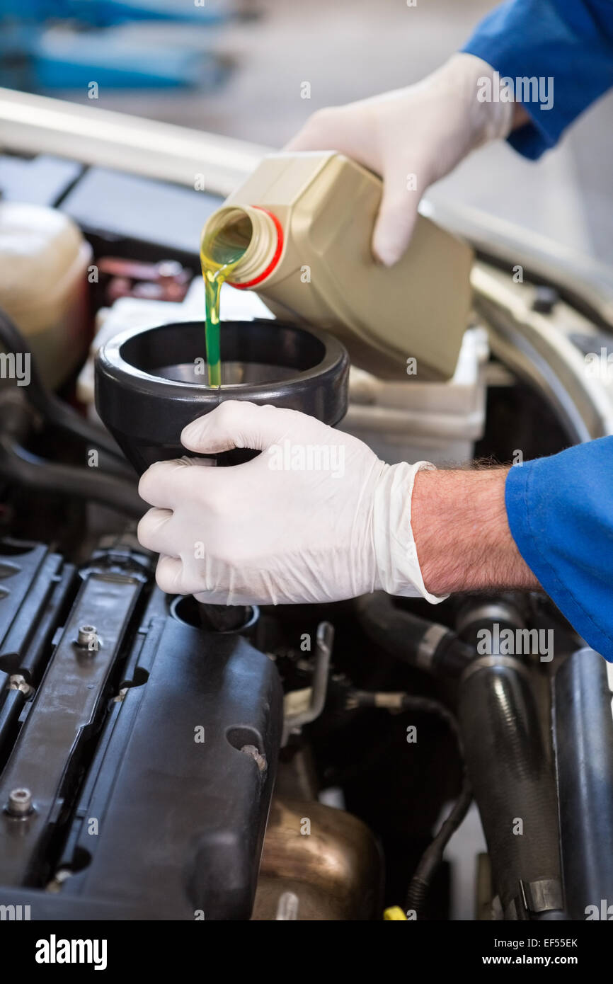 Mechanic pouring oil into car Stock Photo Alamy