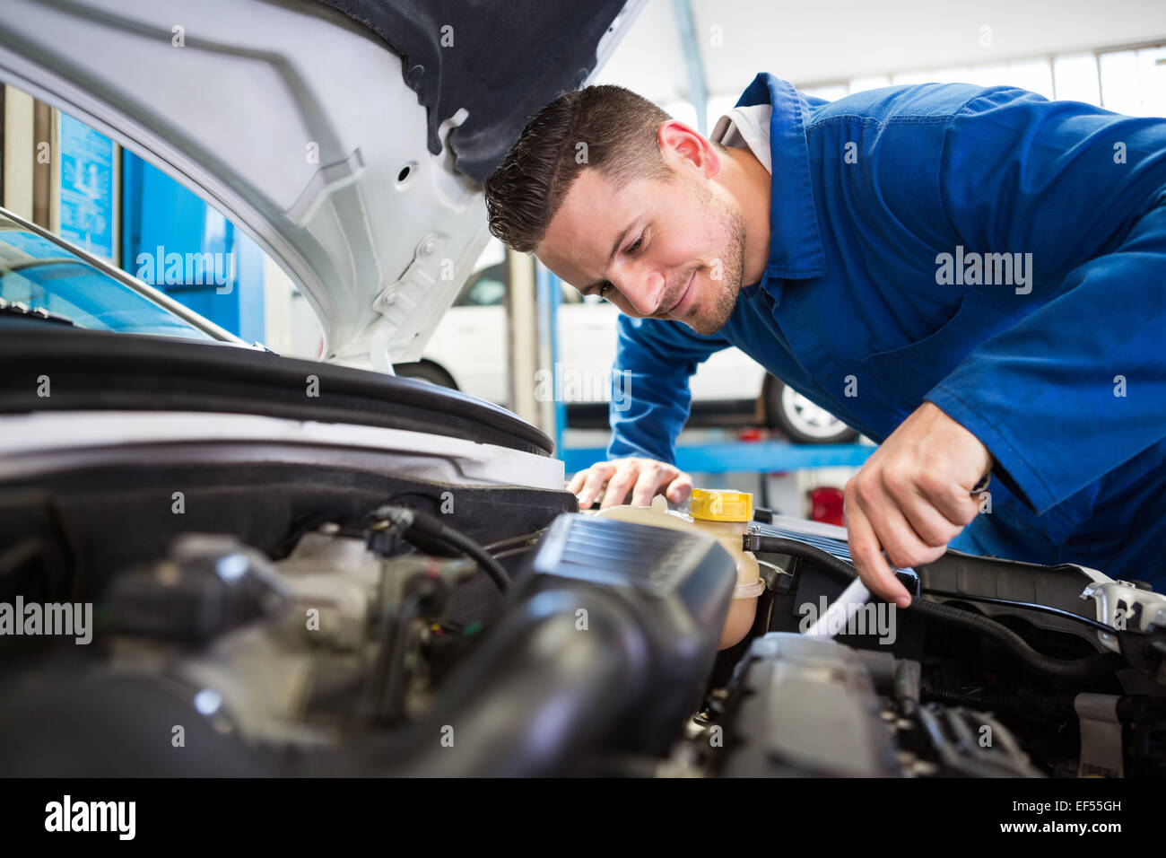 слесарь автосервиса. техническое обслуживание bmw. техобслуживание автомобиля. человек чинит машину. Mechanics.