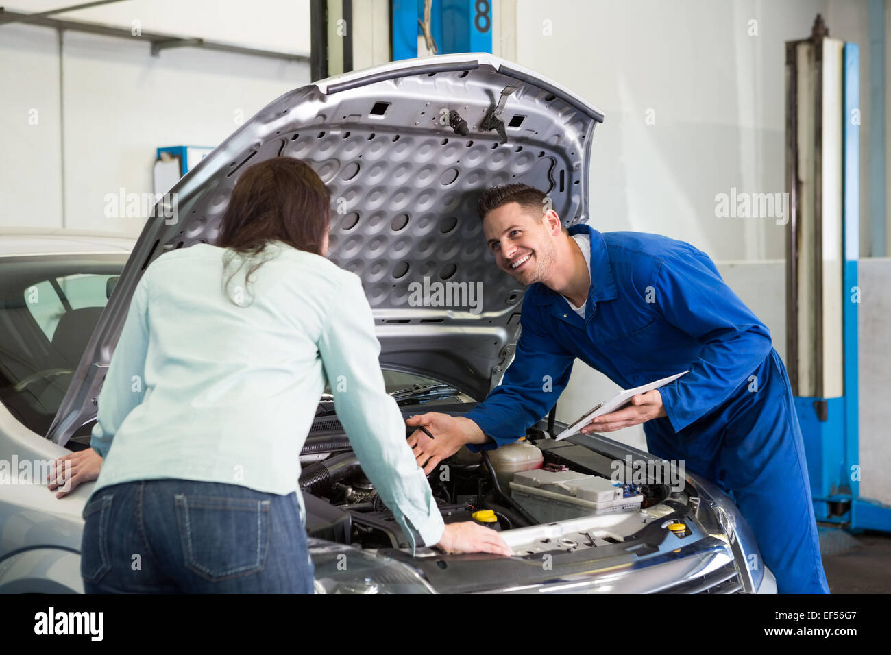 Mechanic showing customer the problem with car Stock Photo Alamy