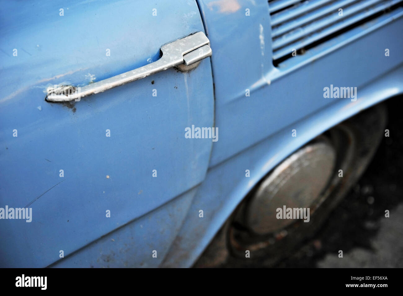 Detail shot with a door handle from an old vintage blue car Stock Photo