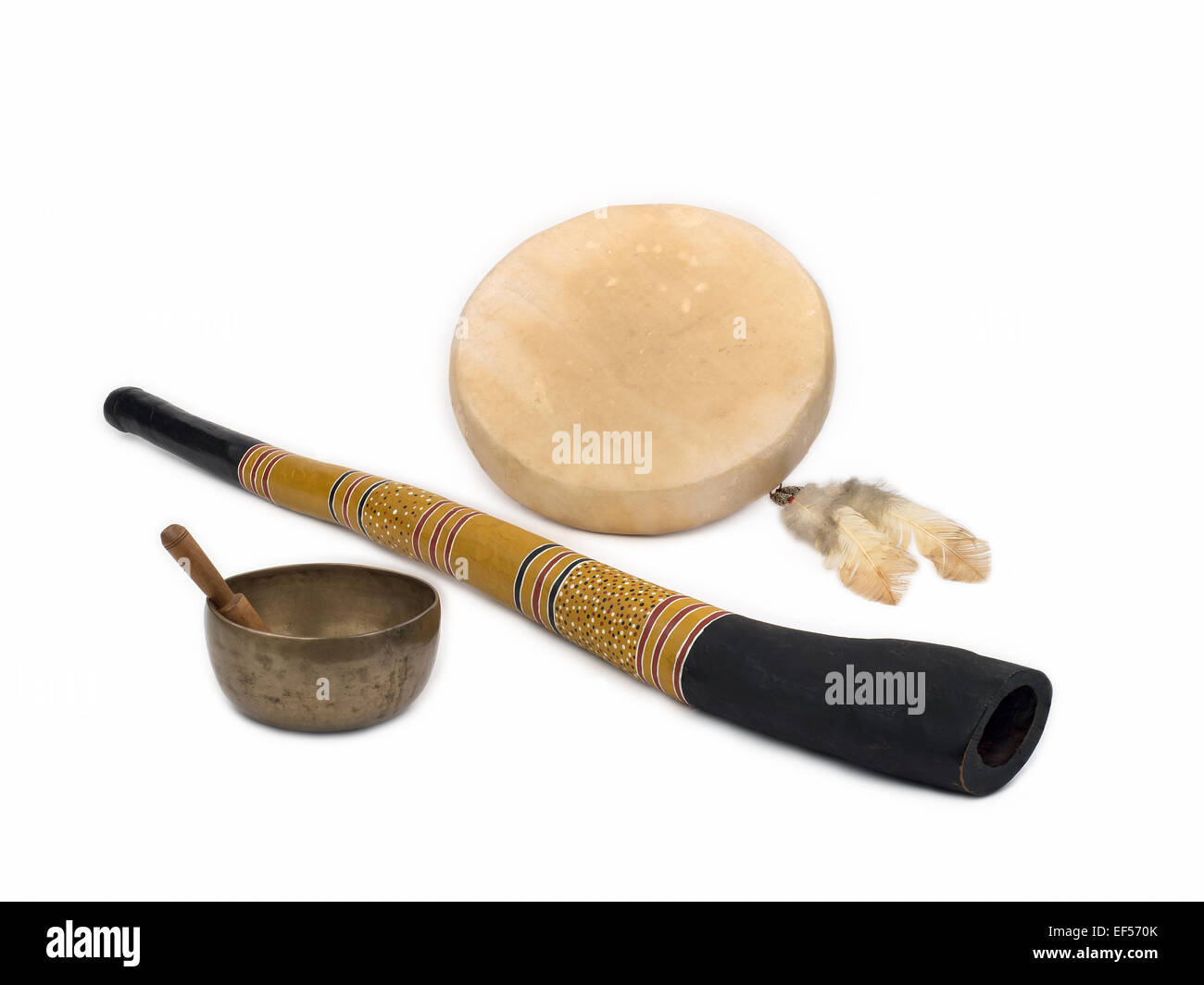 Sound Healing Instruments - Didgeridoo, Native American Drum with Feathers, and Tibetan Singing Bowl. Stock Photo