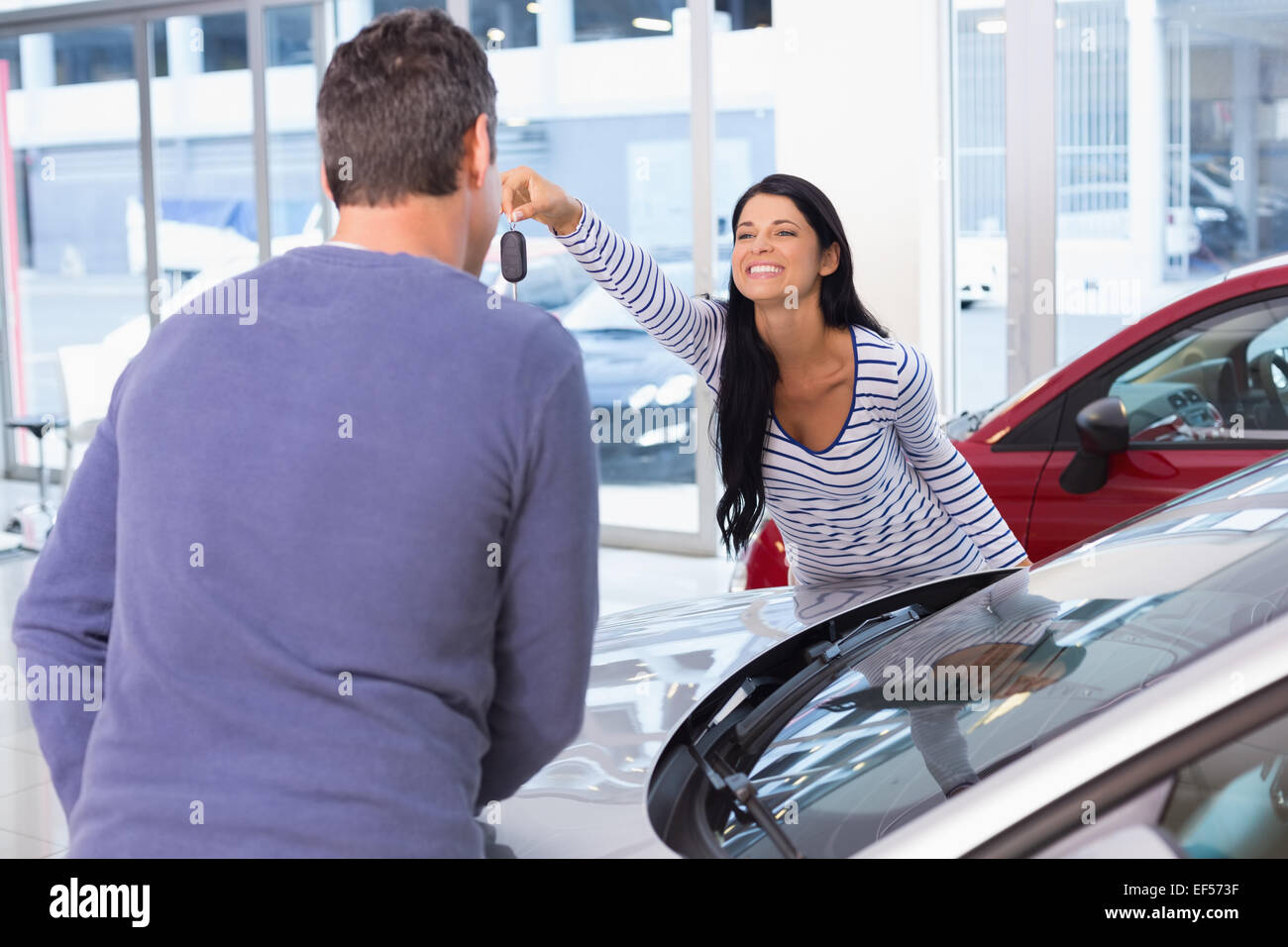 Smiling woman holding her new key Stock Photo - Alamy