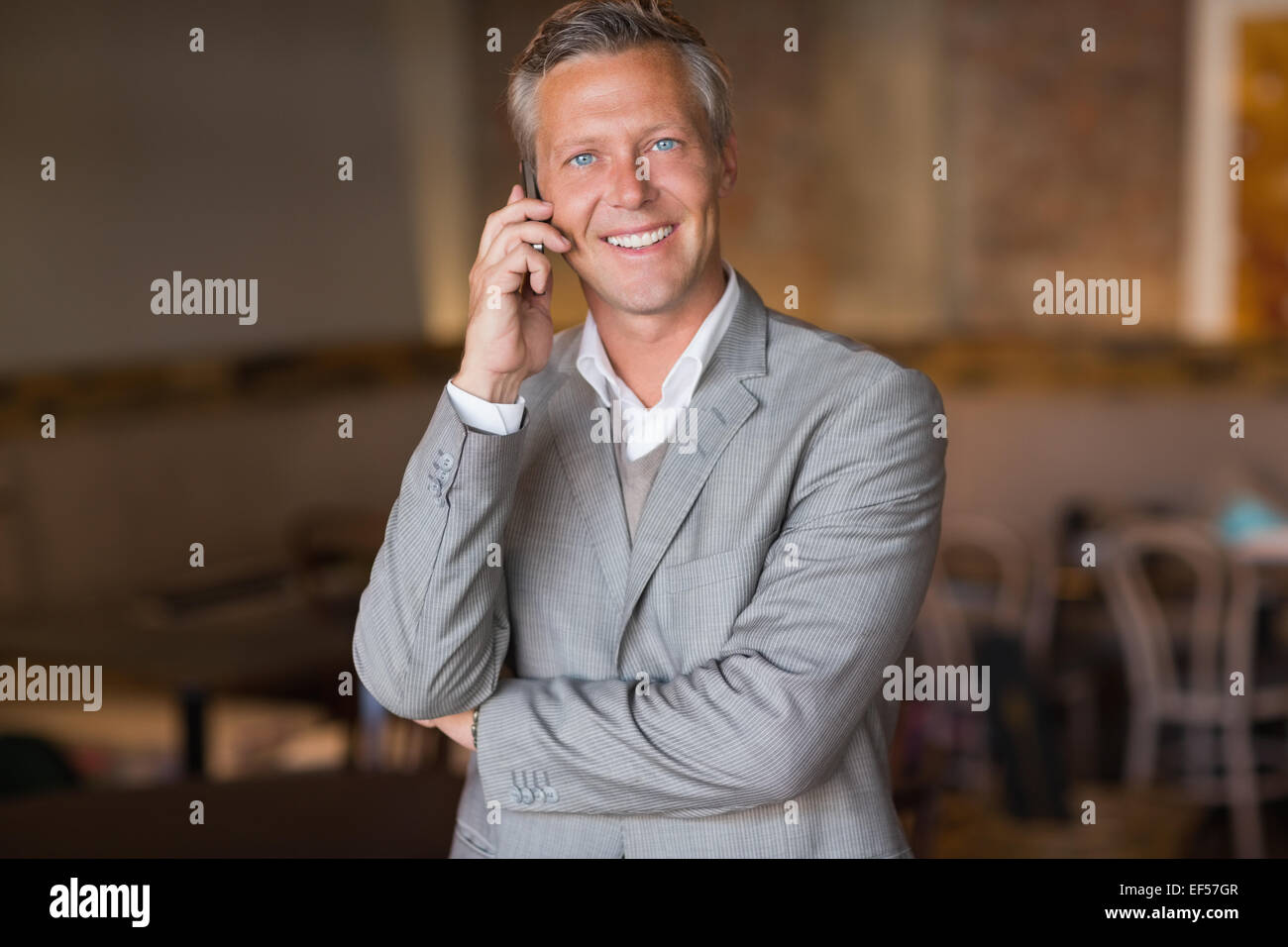 Smiling businessman looking at camera Stock Photo - Alamy