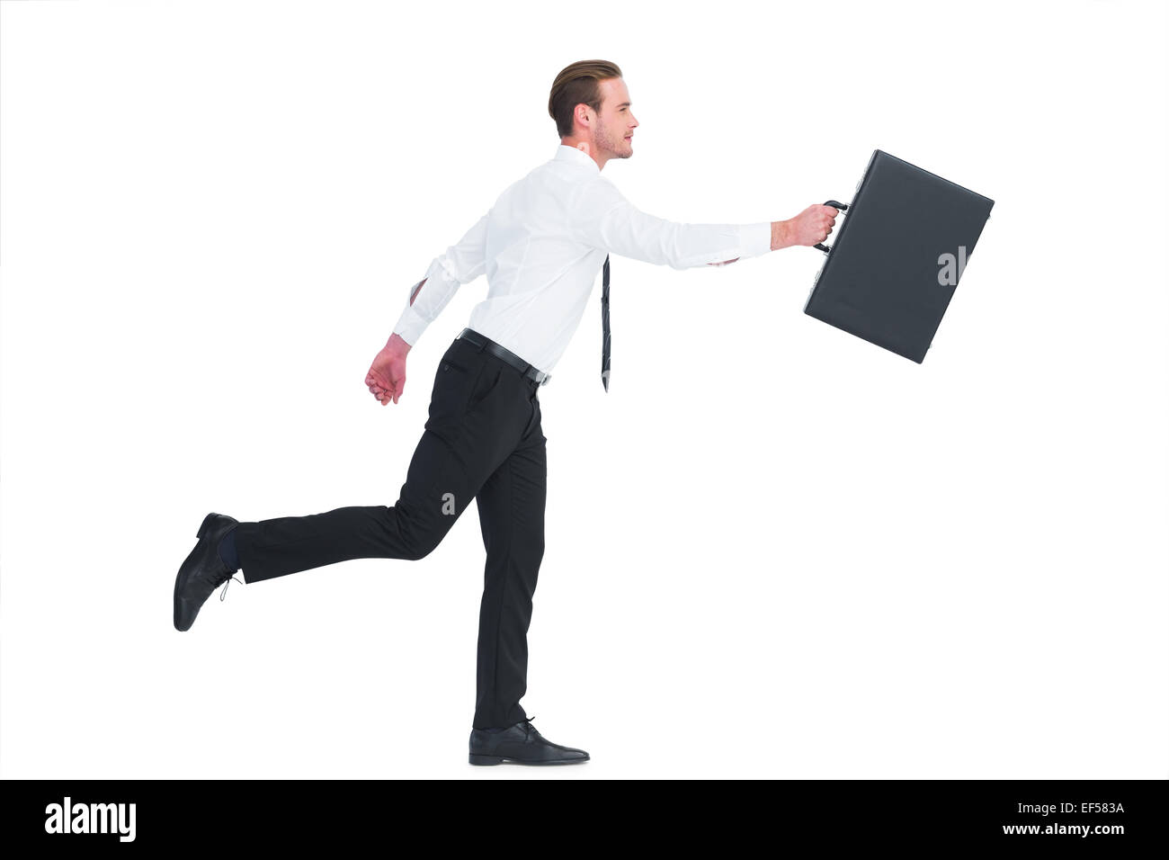 Businessman walking with his briefcase Stock Photo - Alamy