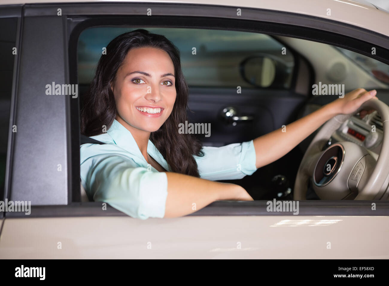 Smiling woman sitting at the wheel of her new car Stock Photo - Alamy