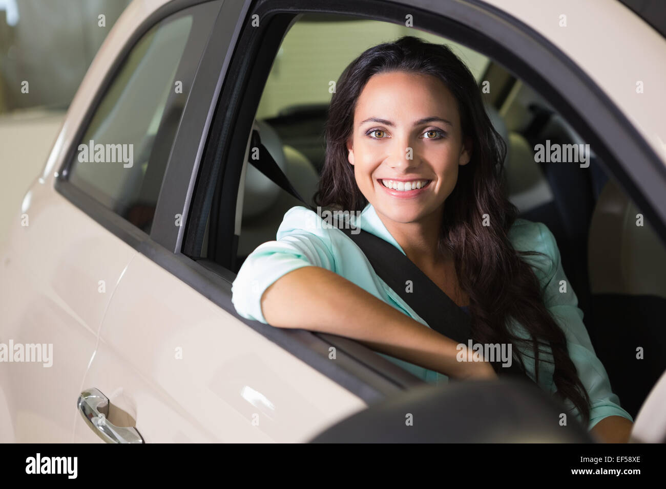 Smiling woman sitting at the wheel of her new car Stock Photo - Alamy