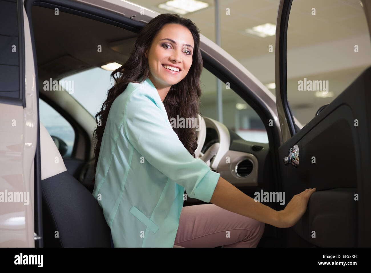 Smiling woman sitting at the wheel of her new car Stock Photo - Alamy