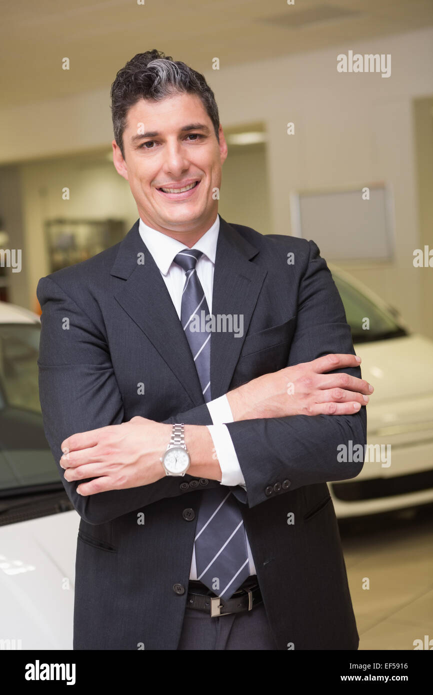 Smiling businessman standing with arms crossed Stock Photo - Alamy