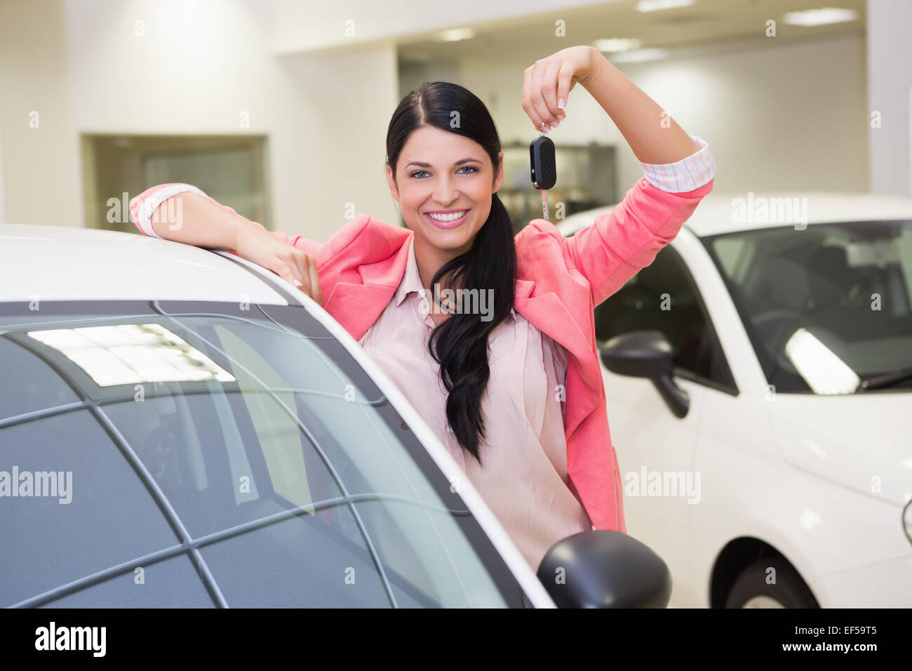Smiling customer showing her new key Stock Photo - Alamy