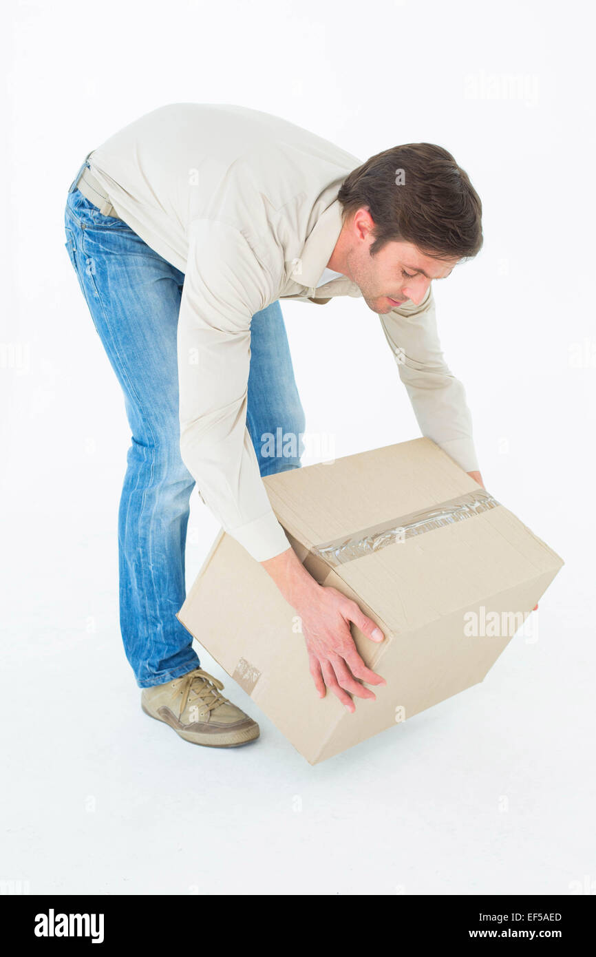 Courier man picking up cardboard box Stock Photo Alamy