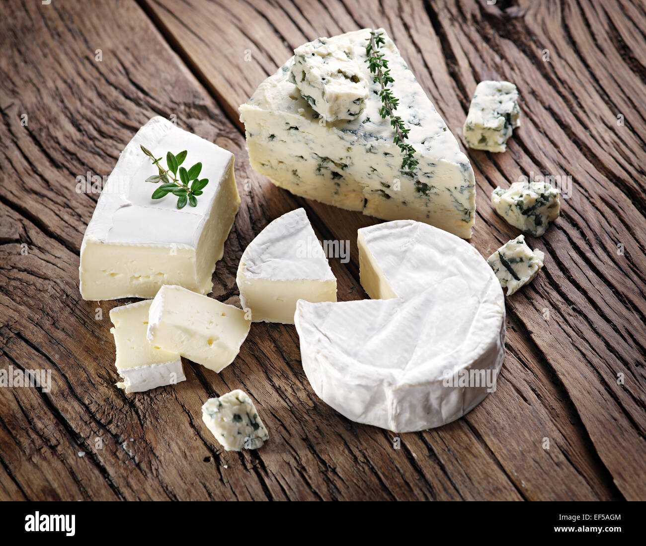 Group of cheese with mold on old wooden table. Stock Photo