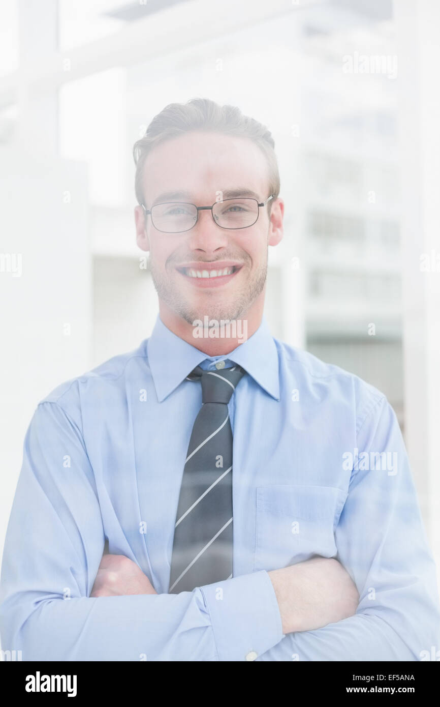 Smiling businessman standing with arms crossed Stock Photo - Alamy