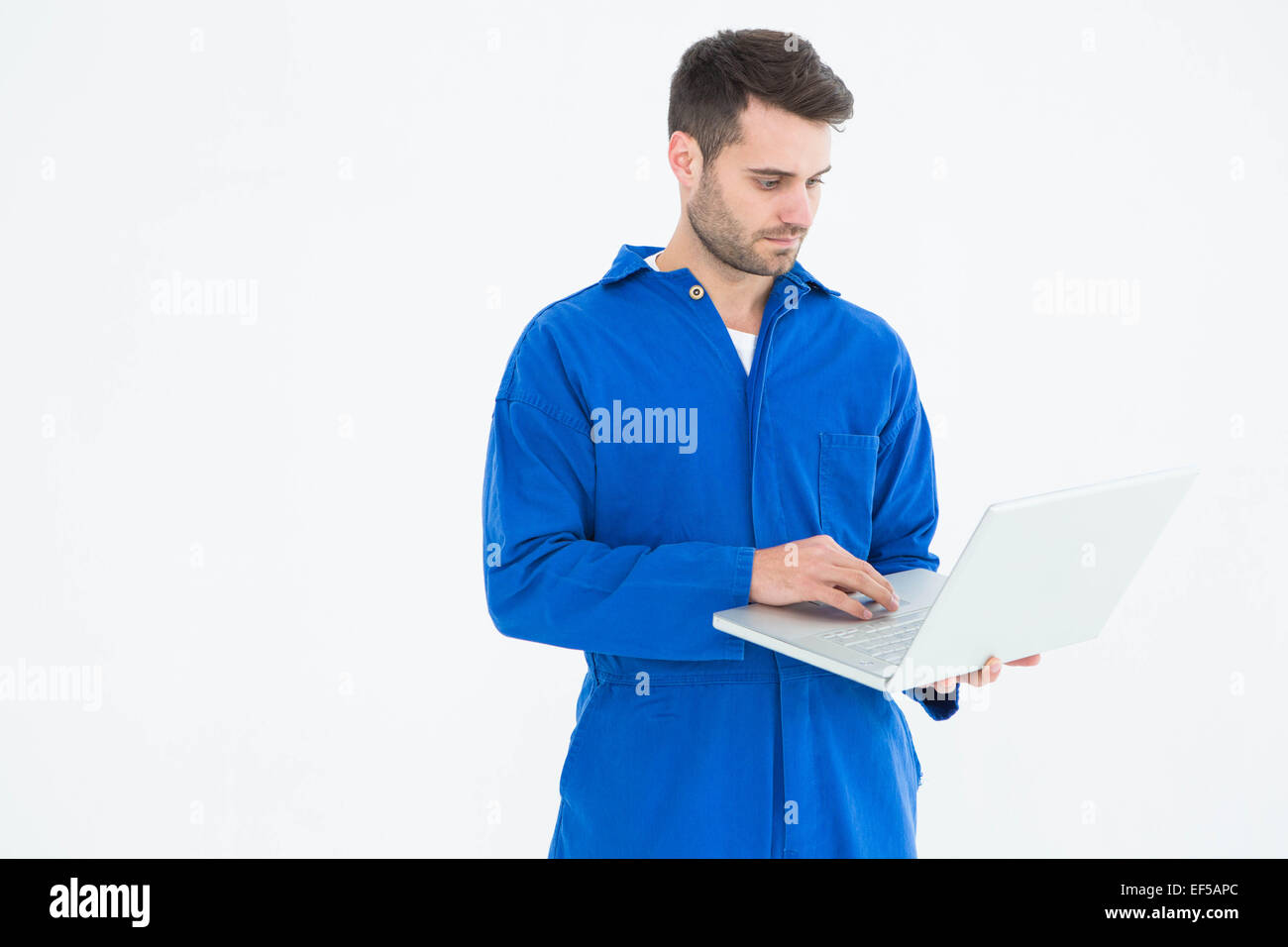 Male mechanic using laptop Stock Photo - Alamy