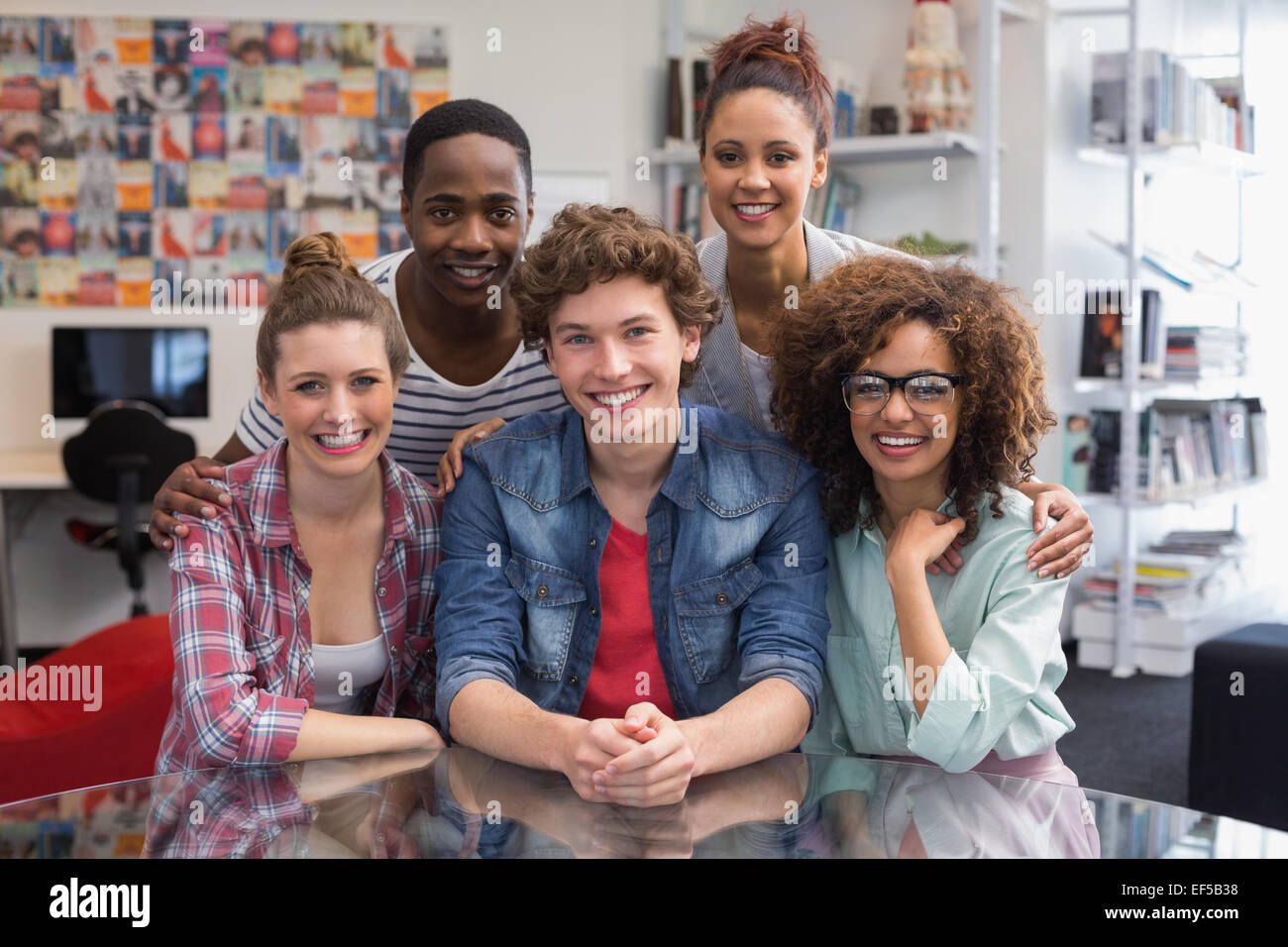 Fashion students smiling at camera together Stock Photo - Alamy