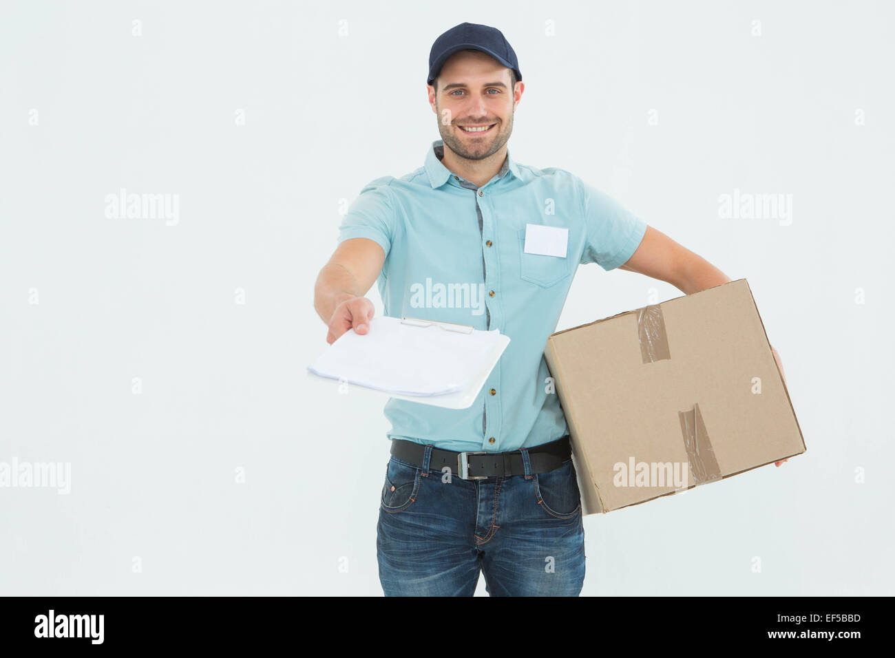Young delivery man giving package hi-res stock photography and images ...
