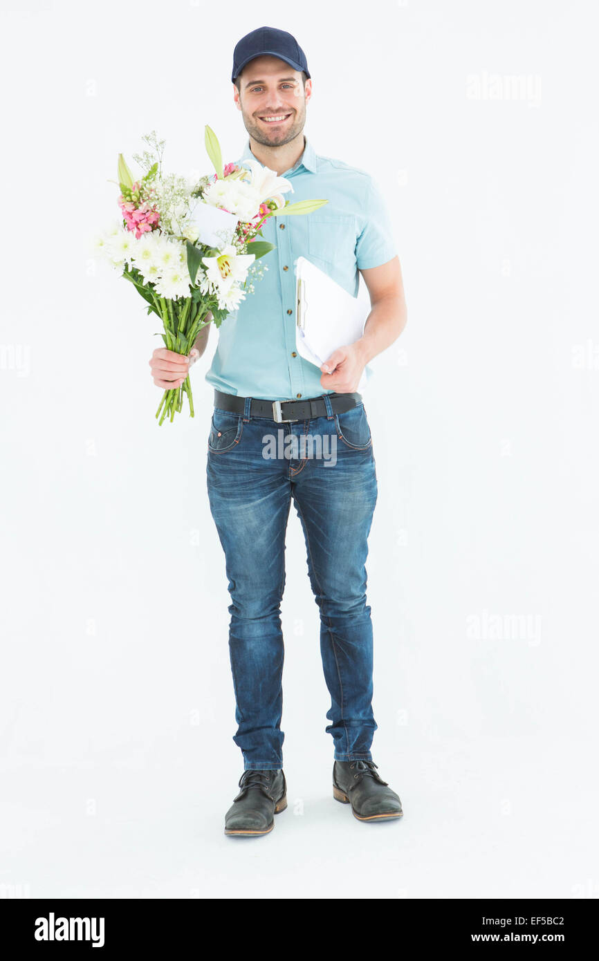 Happy flower delivery man holding clipboard Stock Photo Alamy