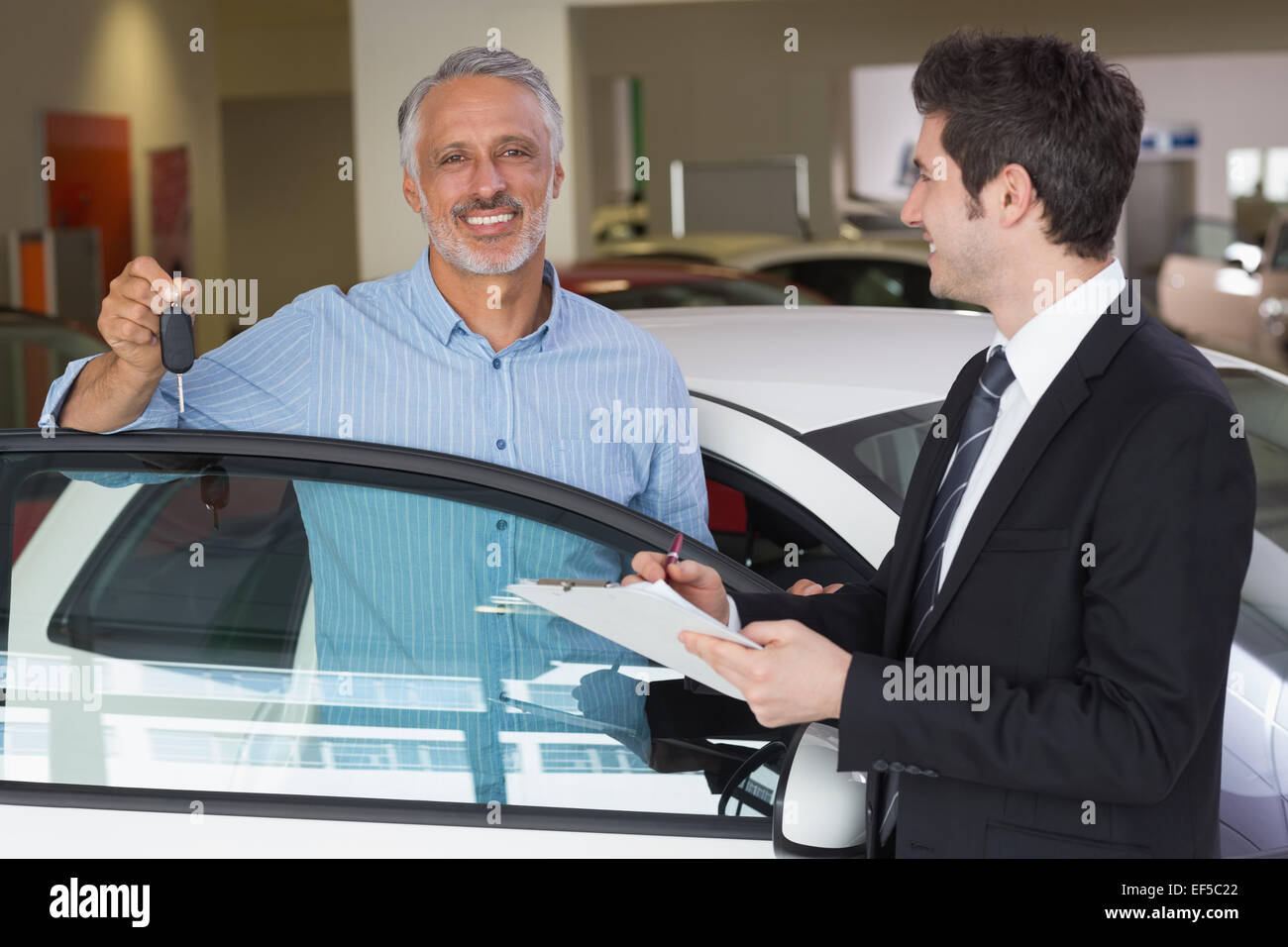 Smiling customer showing his new key Stock Photo - Alamy