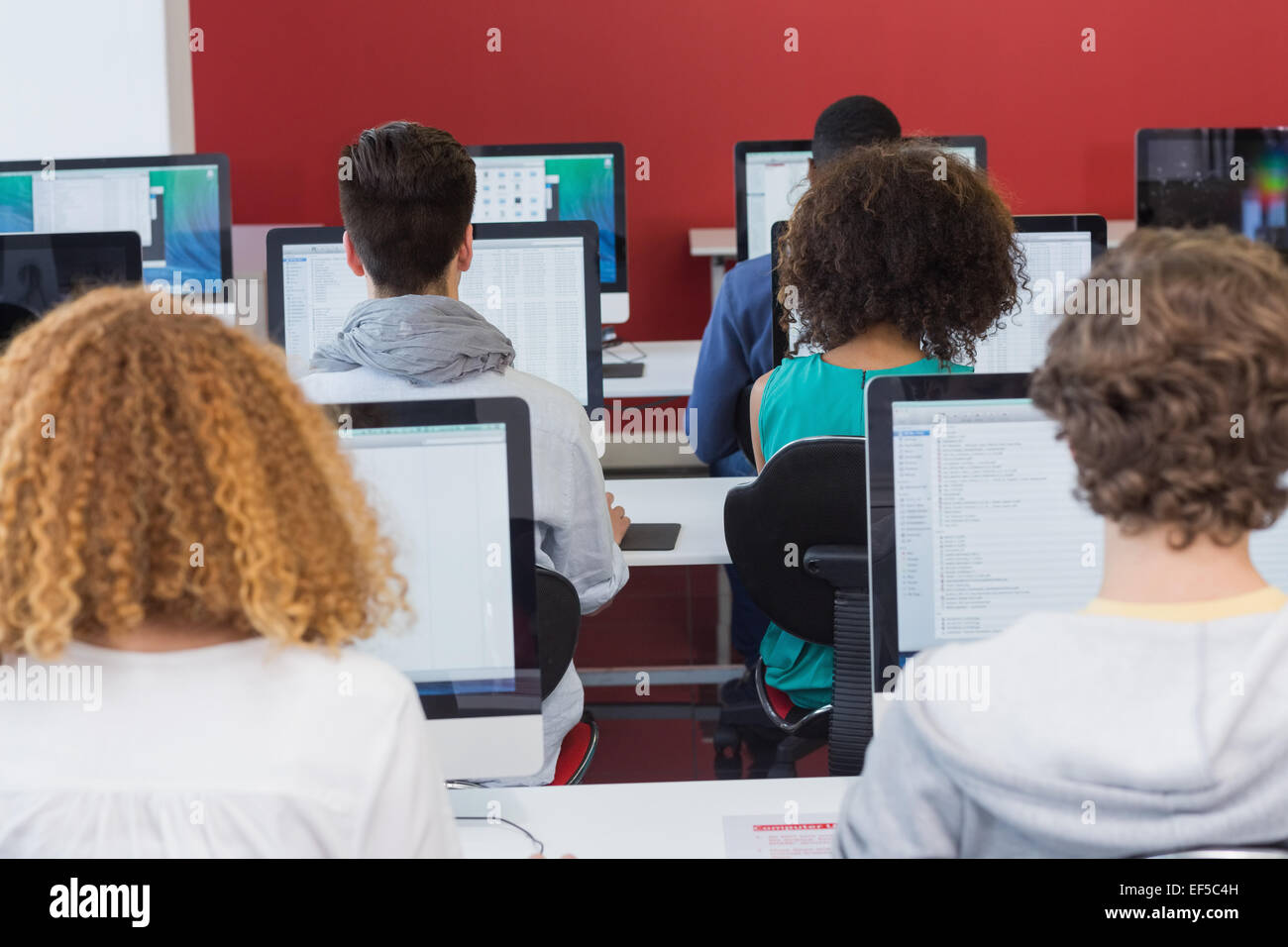 Student smiling at camera in computer class Stock Photo - Alamy