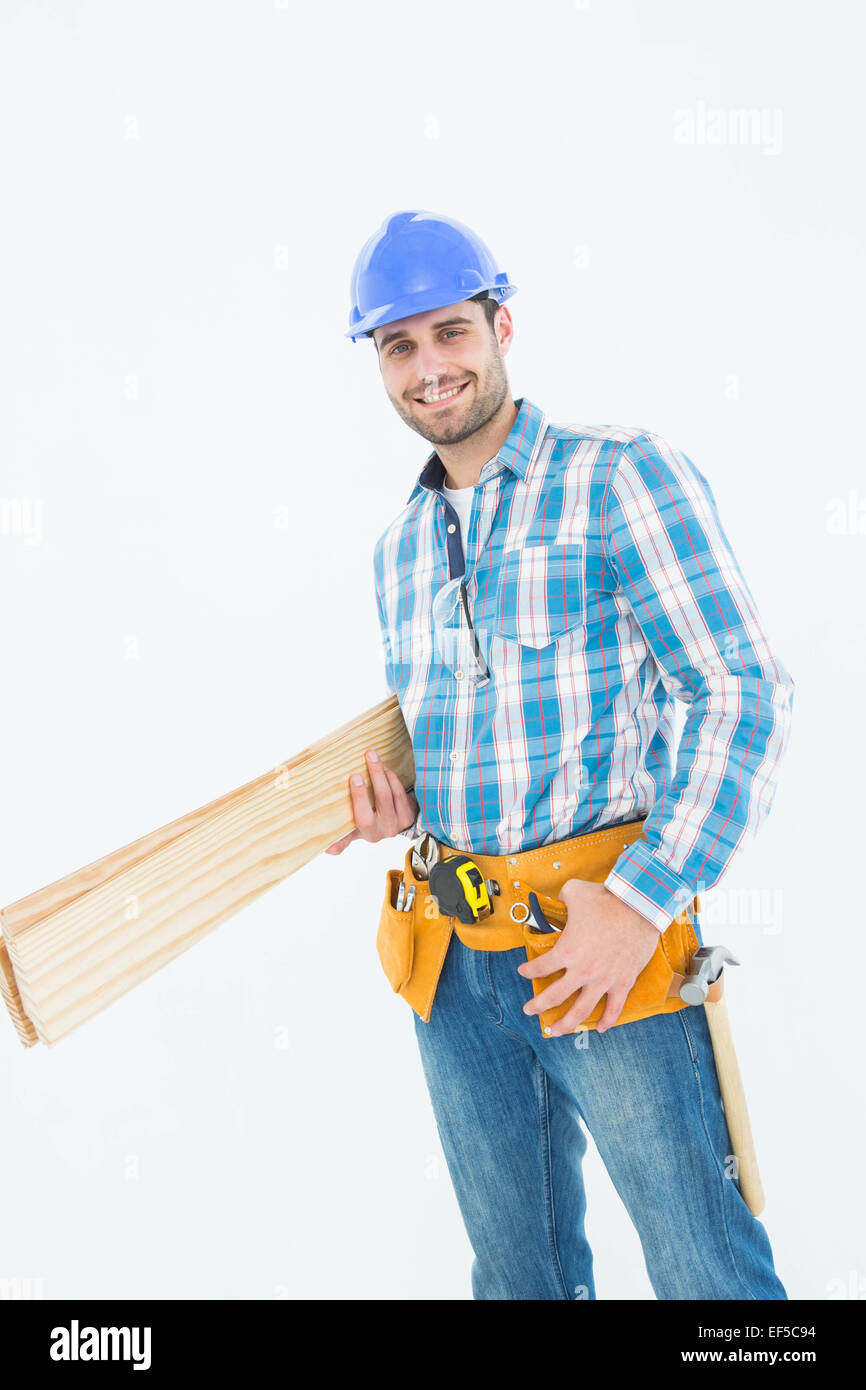Happy construction worker holding wooden planks Stock Photo - Alamy