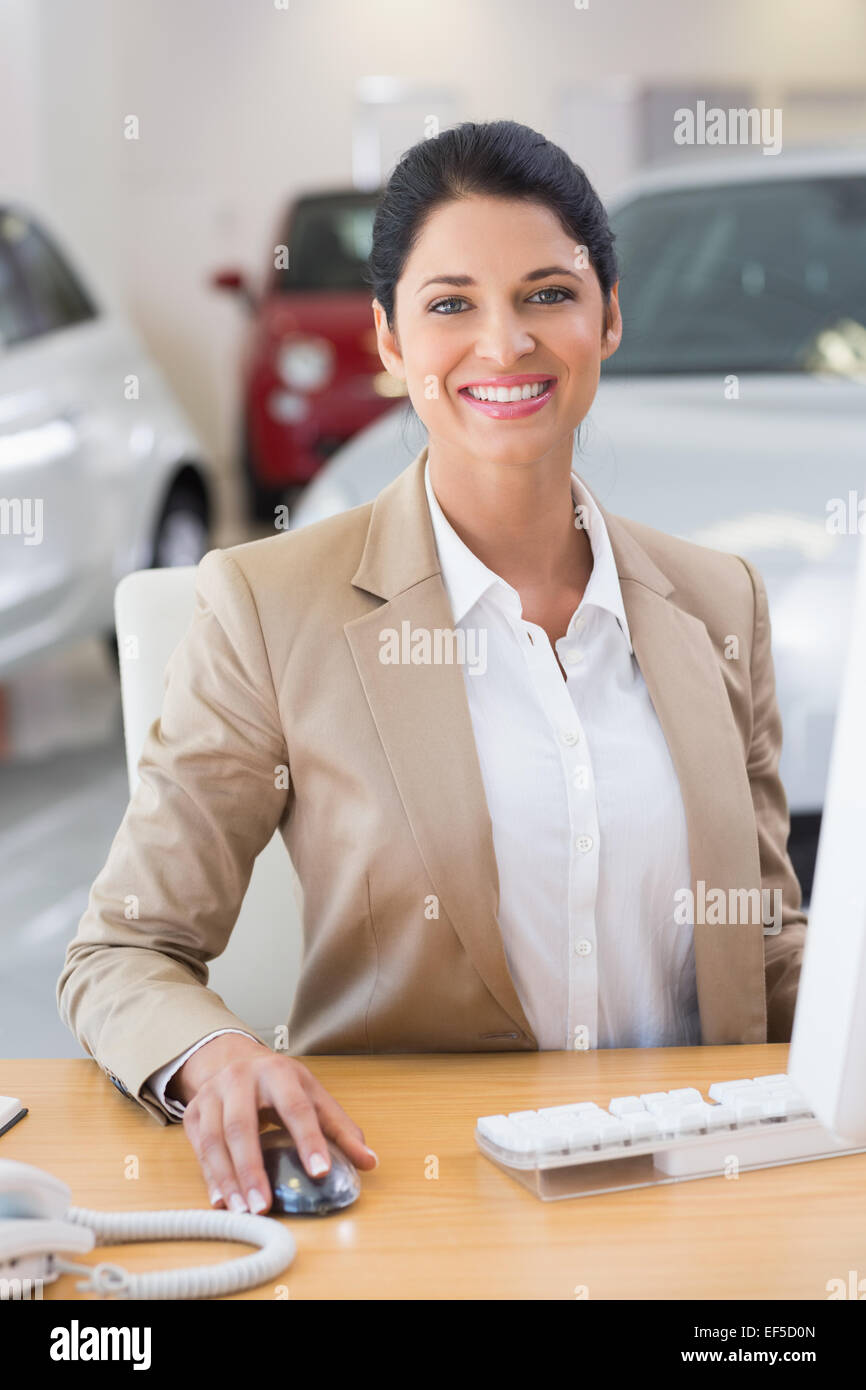 Smiling businesswoman working in her desk Stock Photo - Alamy